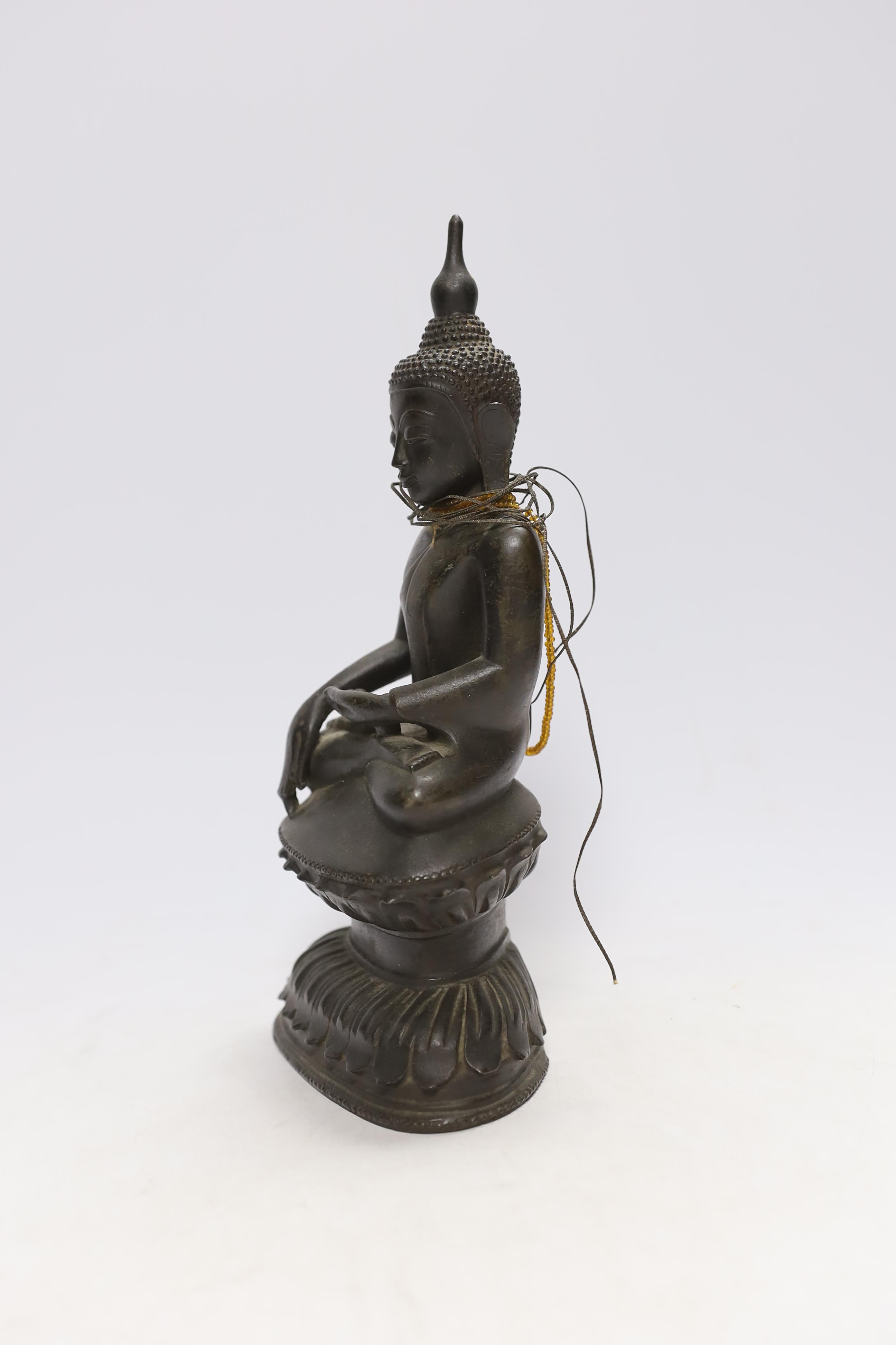 A 19th century Burmese bronze figure of Buddha, 26cm high